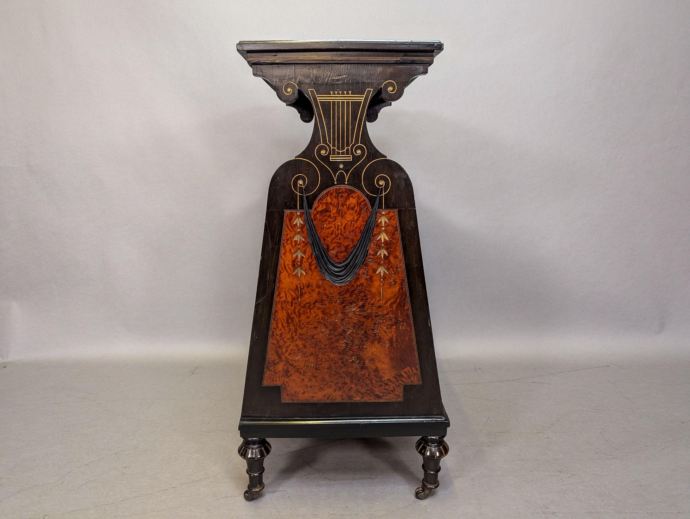 Brass An Aesthetic Movement Amboyna and Ebonized Music Cabinet with gilt decoration For Sale