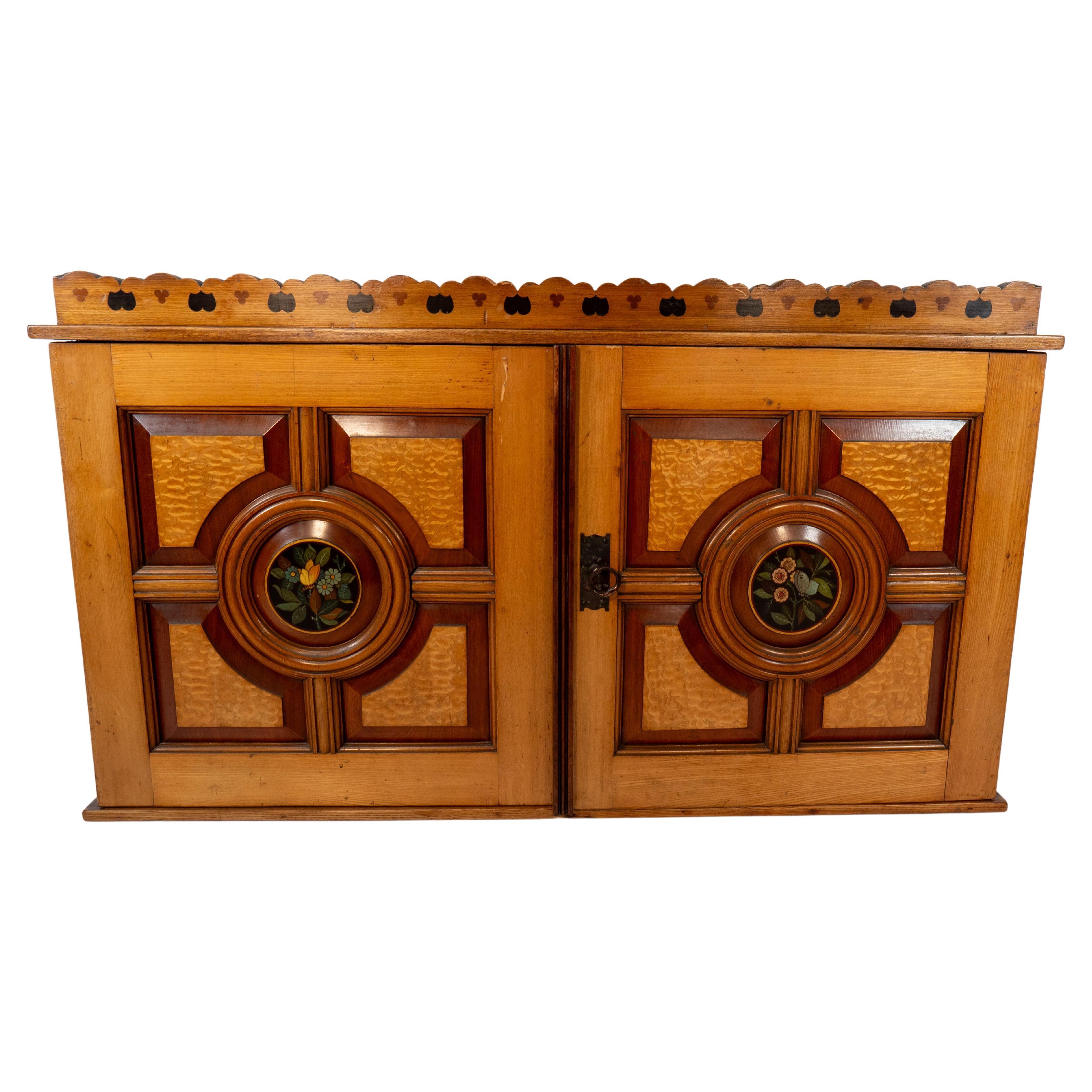 Aesthetic Movement Ash & fiddle back Ash wall cabinet inlaid with floral panels. For Sale