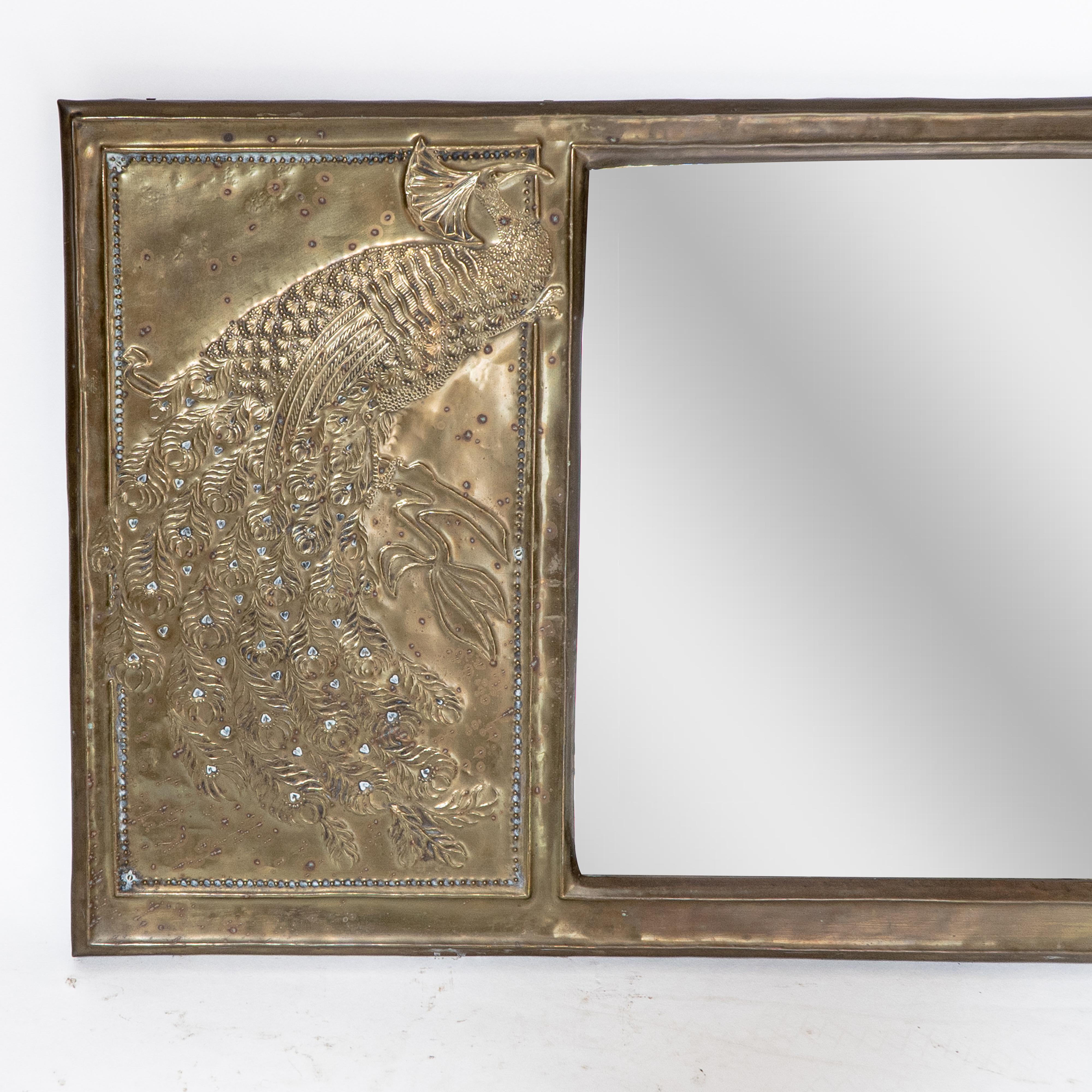 English An Aesthetic Movement brass mirror with stylized peacocks perched on a branch For Sale