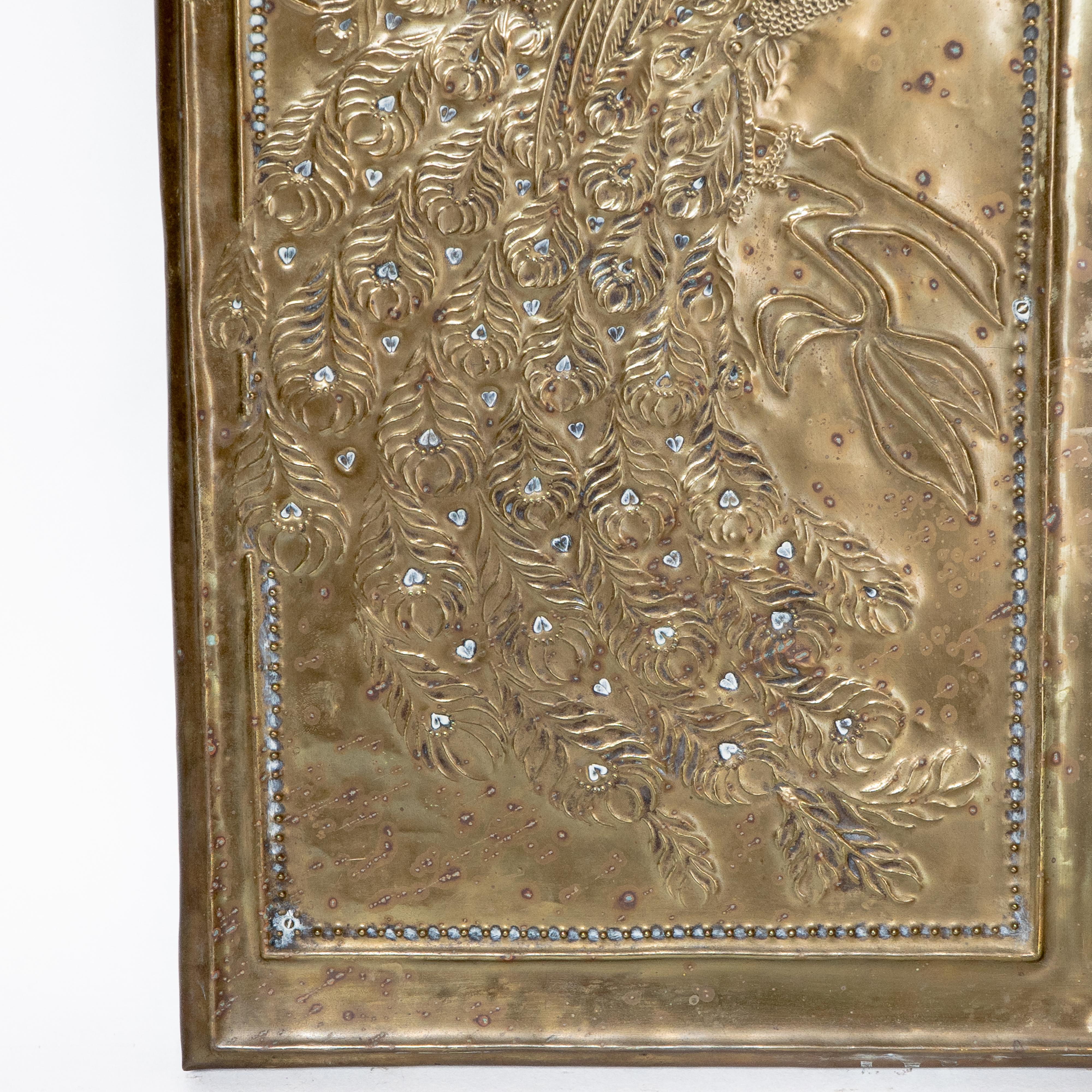 Late 19th Century An Aesthetic Movement brass mirror with stylized peacocks perched on a branch For Sale