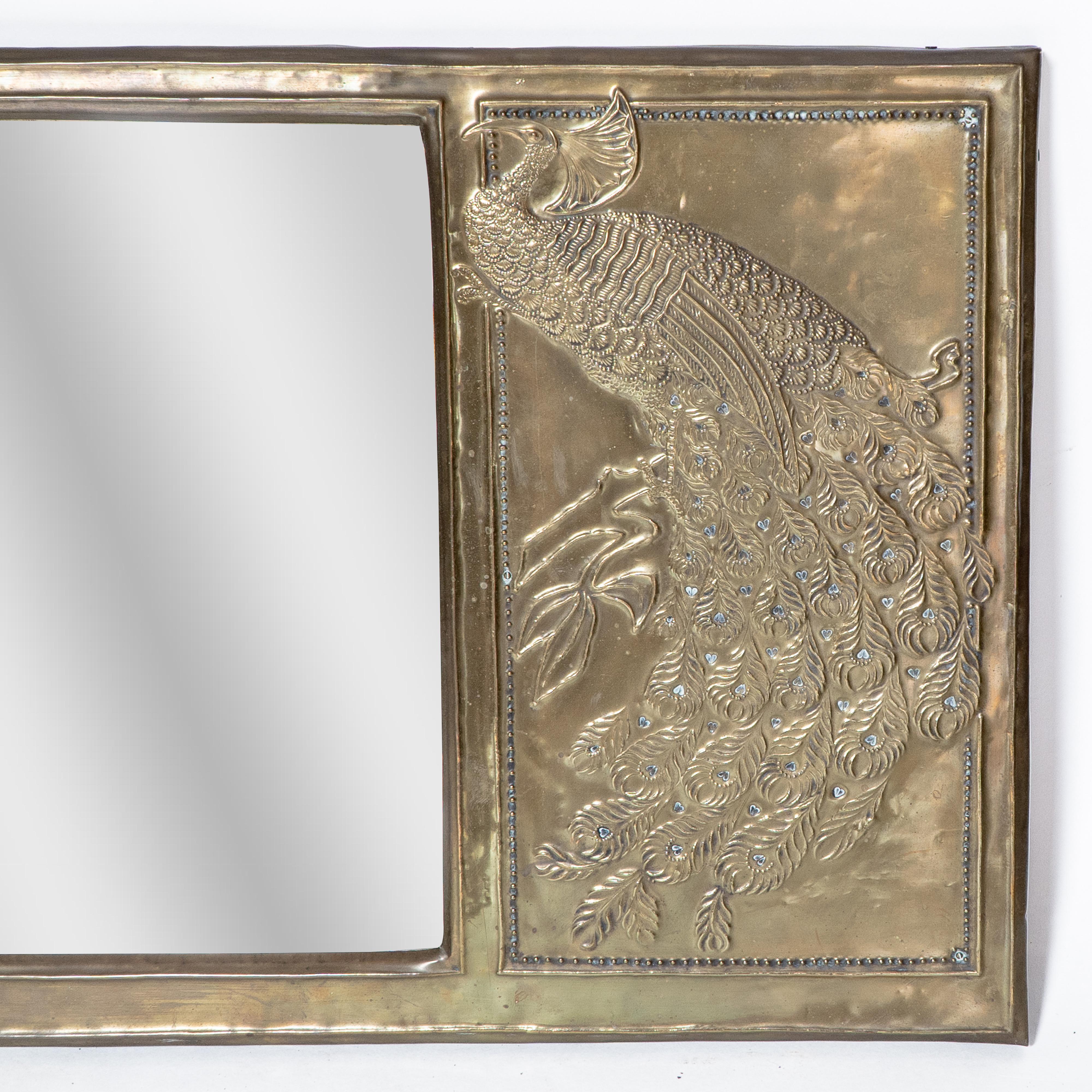 An Aesthetic Movement brass mirror with stylized peacocks perched on a branch For Sale 1
