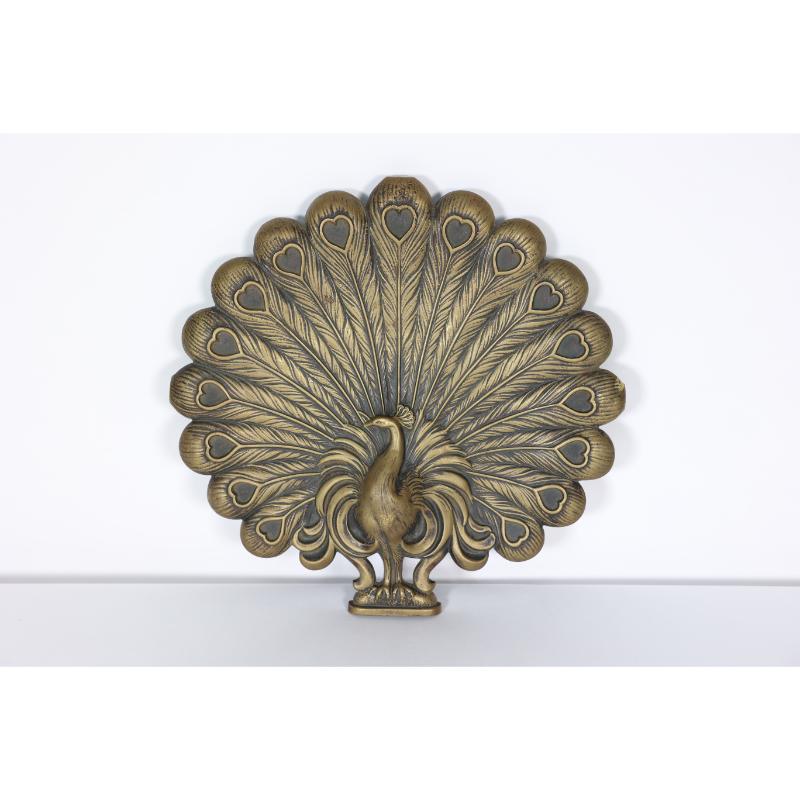 An Aesthetic Movement heavy cast brass peacock trivet with fine detailing throughout.
