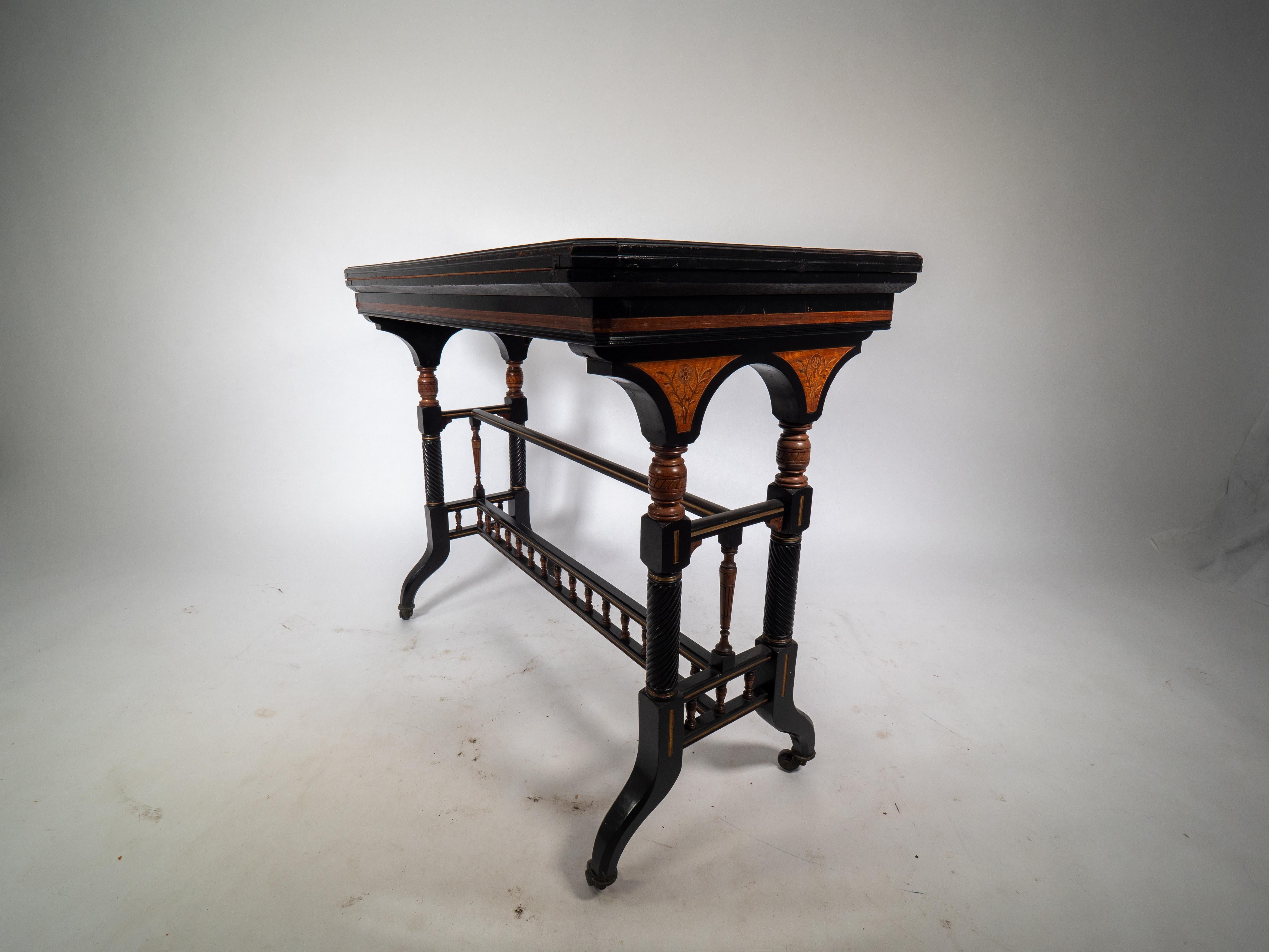 Walnut Gillows attr An Aesthetic Movement ebonized & fold over floral inlaid card table For Sale