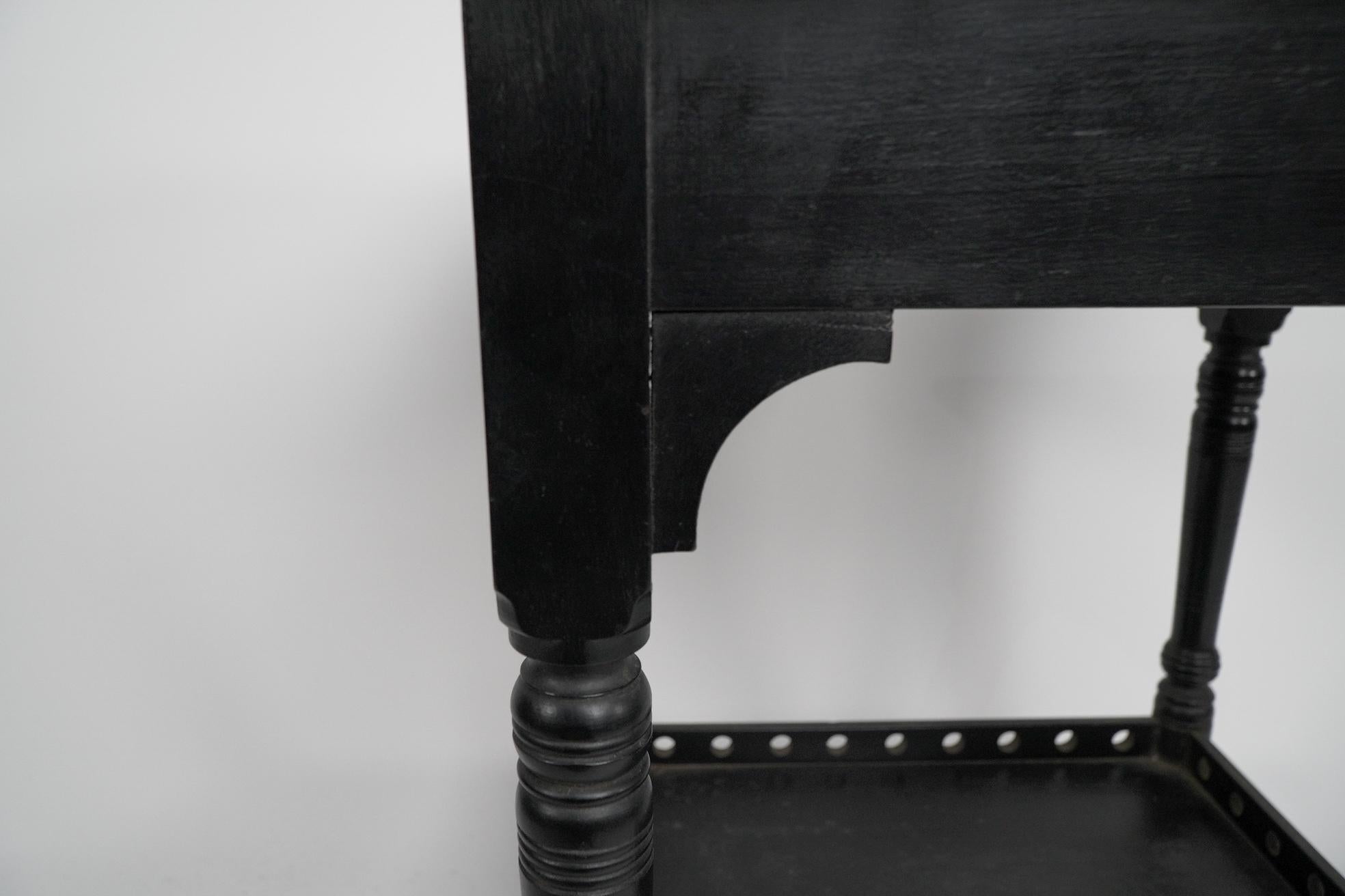 An Aesthetic Movement ebonized walnut two tier side table with a pierced gallery For Sale 1