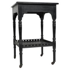 Antique An Aesthetic Movement ebonized walnut two tier side table with a pierced gallery