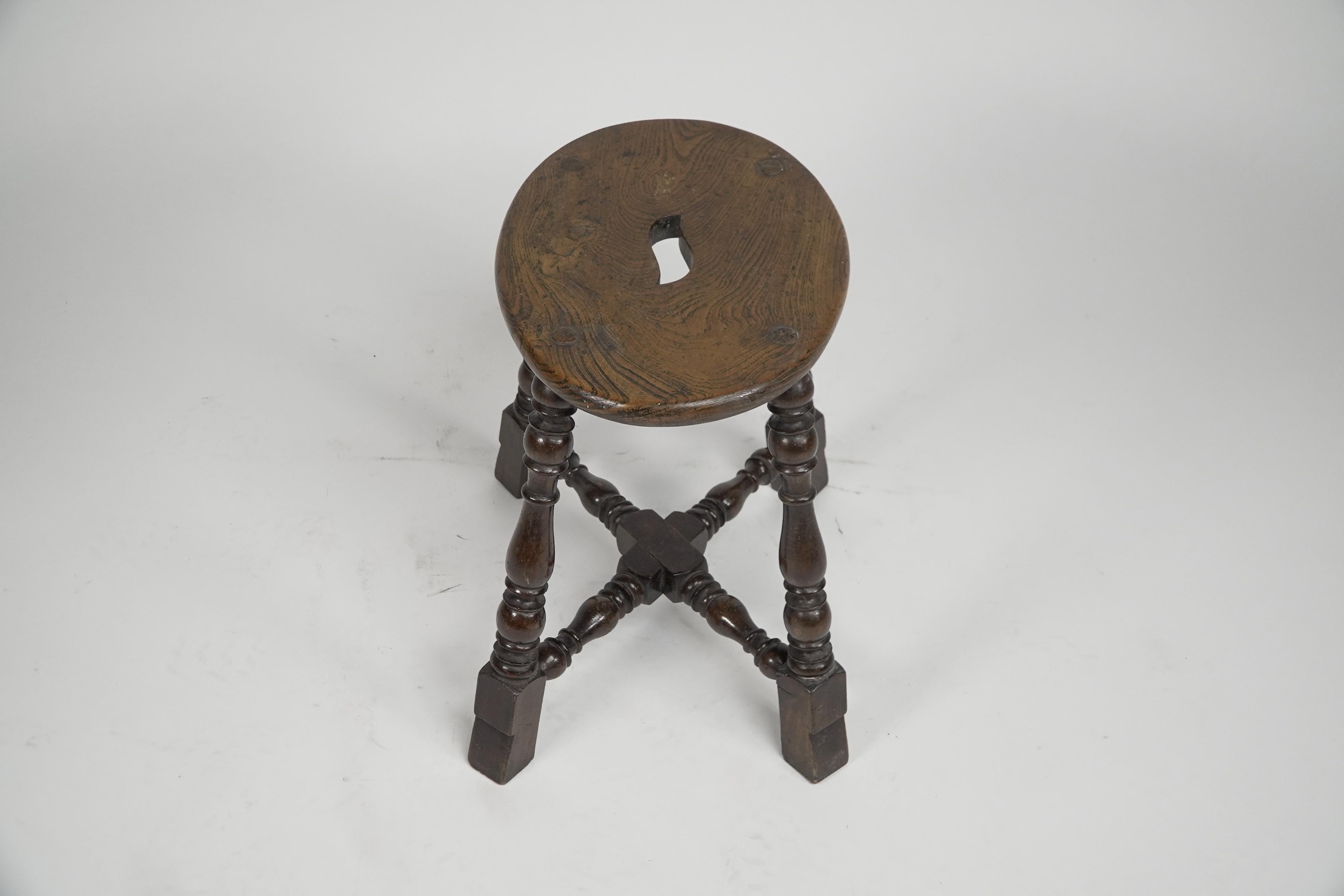 English An Aesthetic Movement Elm stool with a 'S' handle, and a wild grain to the seat. For Sale