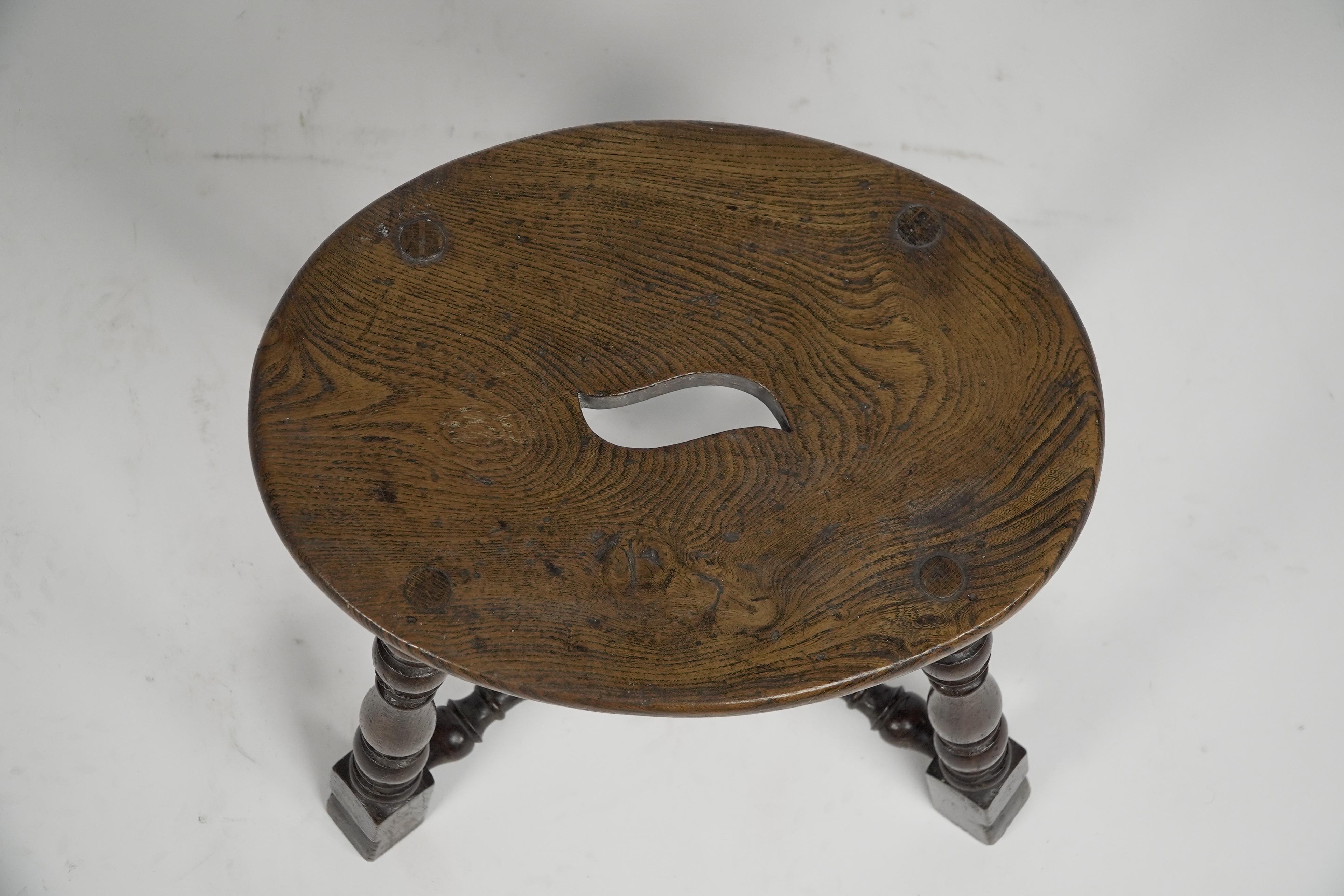 An Aesthetic Movement Elm stool with a 'S' handle, and a wild grain to the seat. For Sale 4