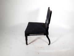 An Aesthetic Movement low side chair with fretwork to the lower back rest