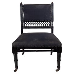 An Aesthetic Movement low side chair with fretwork to the lower back rest