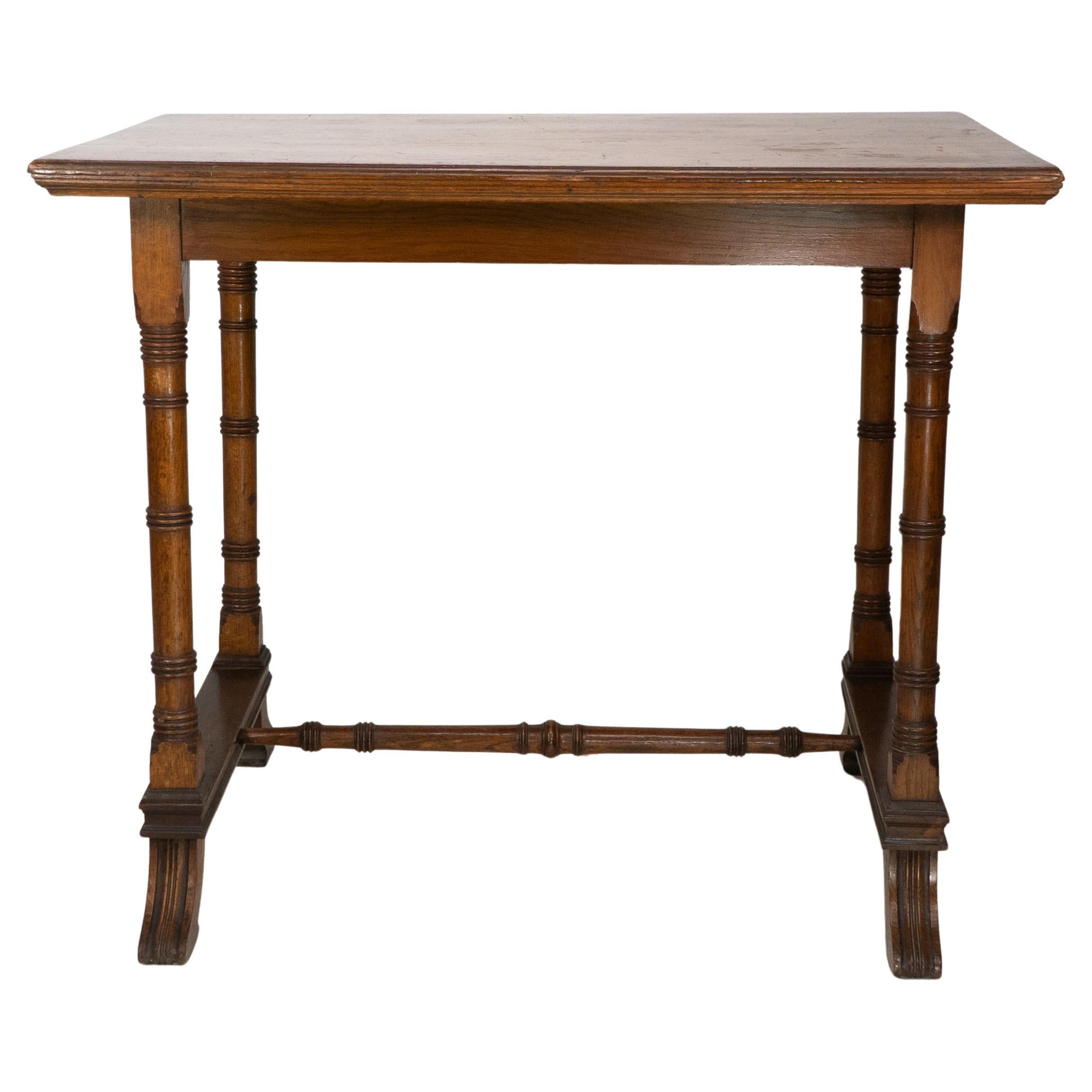 An Aesthetic Movement oak oblong side table with staggered ring turnings to the legs and stood on splayed-out feet united by a fine ring-turned central stretcher.
