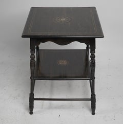 An Aesthetic Movement rosewood two tier side table inlaid with floral decoration