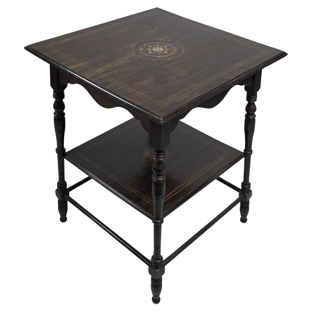 An Aesthetic Movement rosewood two tier side table inlaid with floral decoration