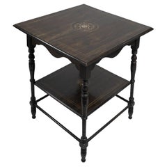 An Aesthetic Movement rosewood two tier side table inlaid with floral decoration
