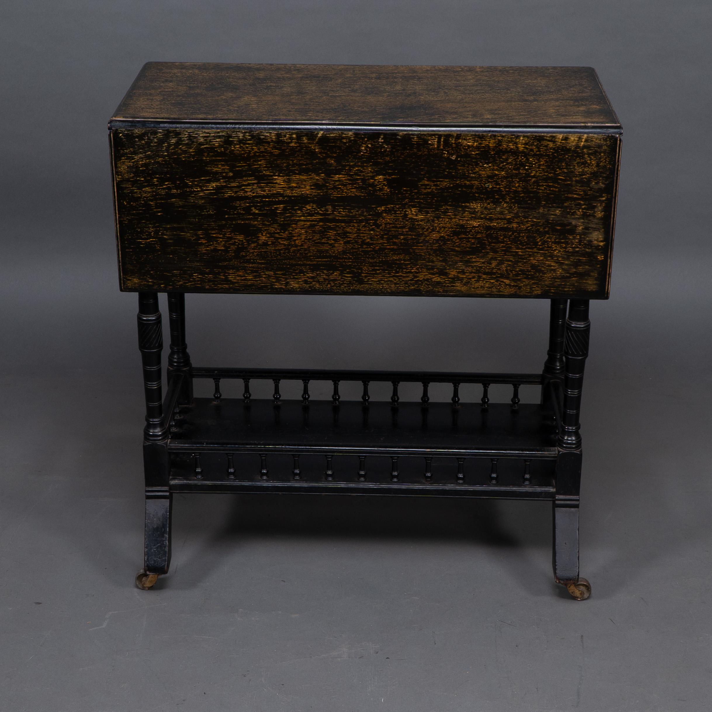 A small Aesthetic Movement Walnut drop leaf side table on four turned and incised legs united by a lower stretcher with a turned gallery arround on original brass and ceramic castors. Folded: Height 65 cm x Width 39 cm x 61 Depth cm Unfolded: Height