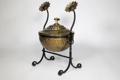 An Aesthetic Movement wrought iron and copper fire bucket with sunflower finials