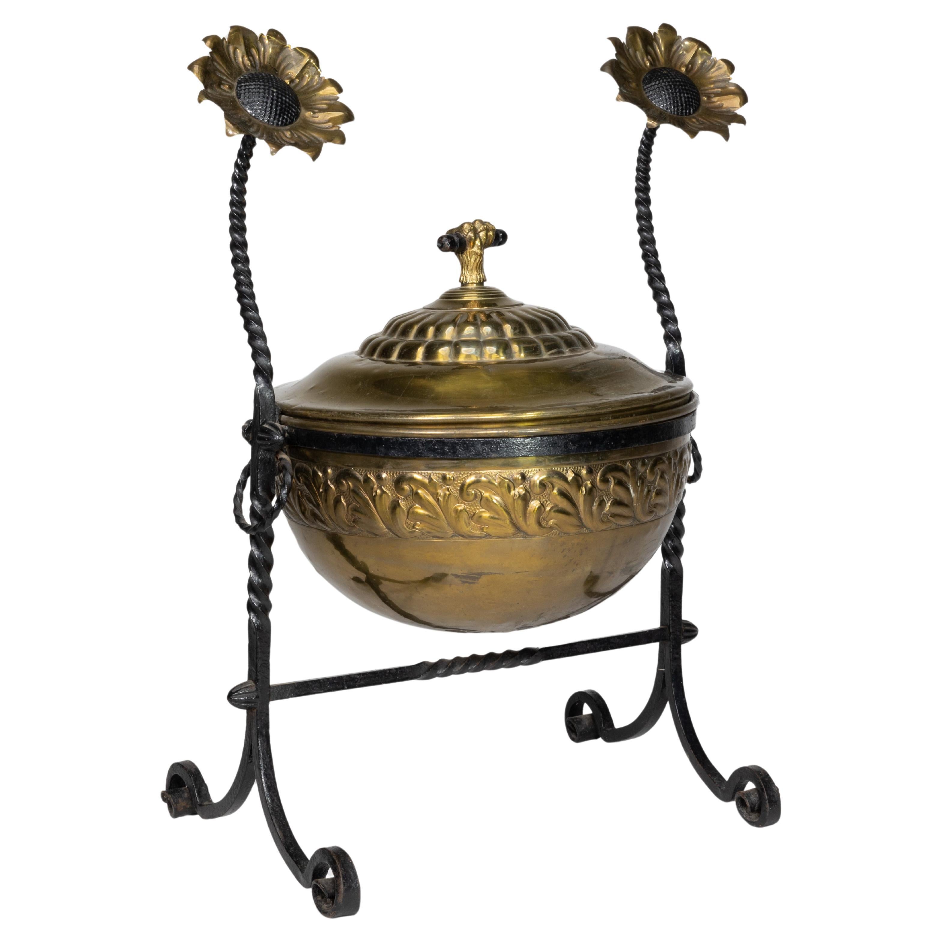 An Aesthetic Movement wrought iron and copper fire bucket with sunflower finials