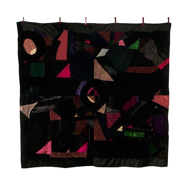 This is an African-American quilt with great graphics. It is made from plain and patterned velvets and fake fur, hand pieced and appliqued onto a muslin backing to give a quilted effect without an extra layer of quilting stitches. There is no