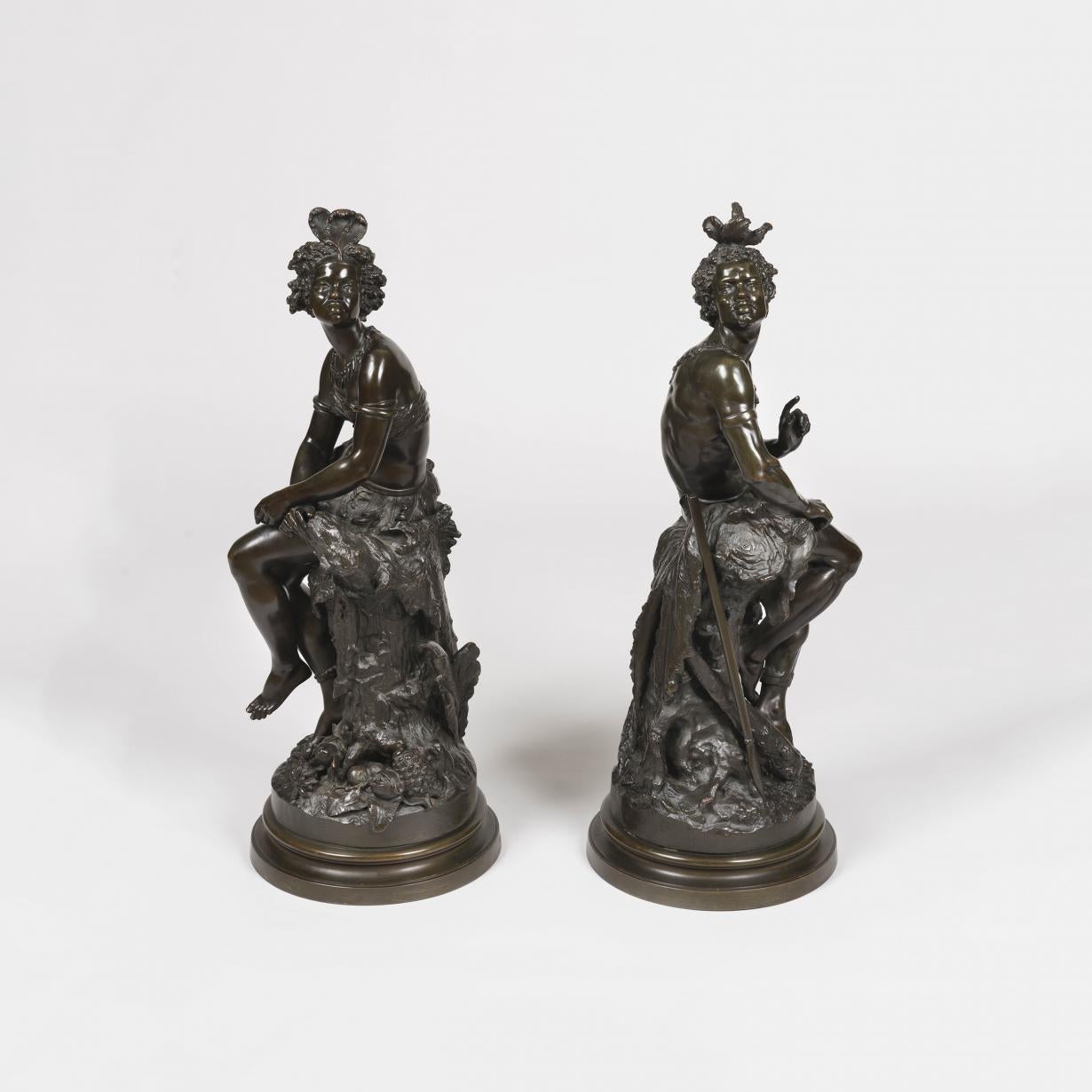 An African couple by Frédérick Eugène Piat (1827-1903)

Modelled in a now well patinated bronze, the circular bases, inscribed with the artist's name, support tree trunks, against which rest the young warrior holding his spear, and his partner, a