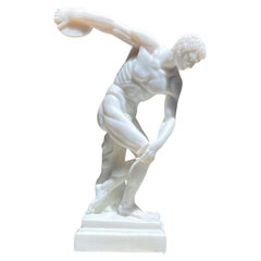An alabaster neoclassical sculpture of an Olympian disc-thrower, 20th century