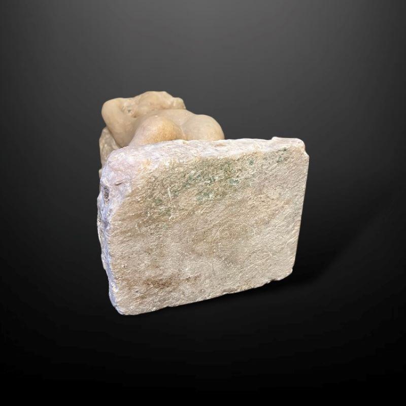 This highly decorative piece depicts the image of a young figure, their position is standing, weight bearing on the left leg with the other resting back, arms raised with hands cradled above the head.

Most likely a memorial piece that was
