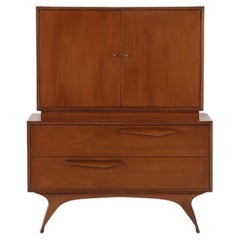 An Albert Parvin style mid century modern walnut highboy dresser.