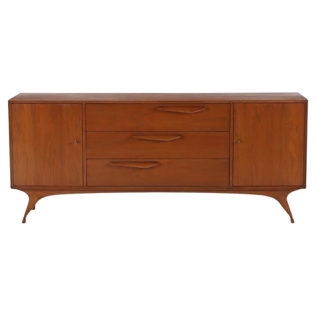 An Albert Parvin style walnut mid century modern nine drawer dresser.