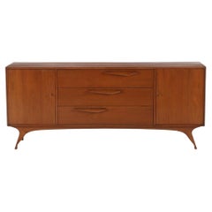 An Albert Parvin style walnut mid century modern nine drawer dresser.