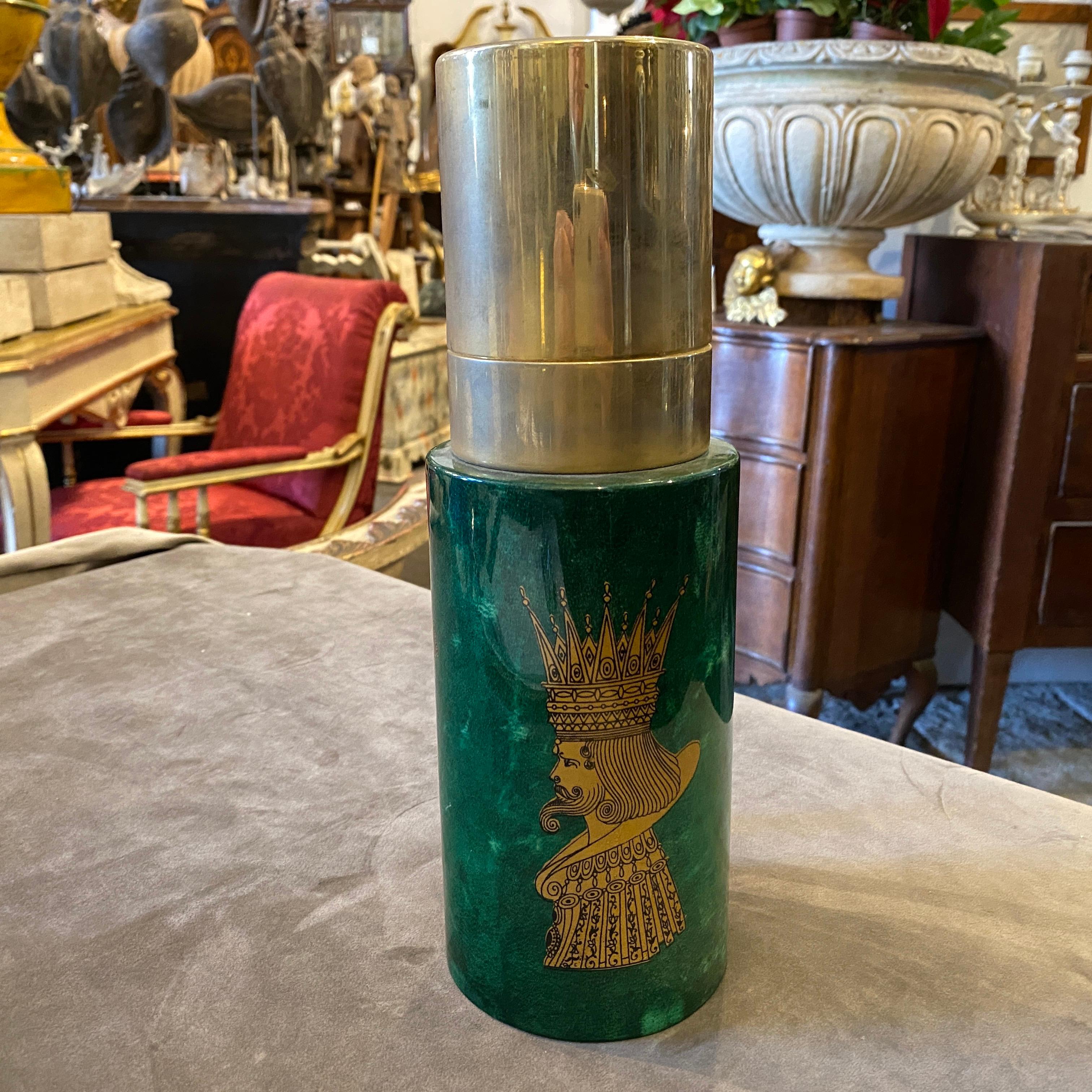 A stylish goatskin carafe decorated with three light brown images in the style of Fornasetti, labeled Aldo Tura on the bottom.