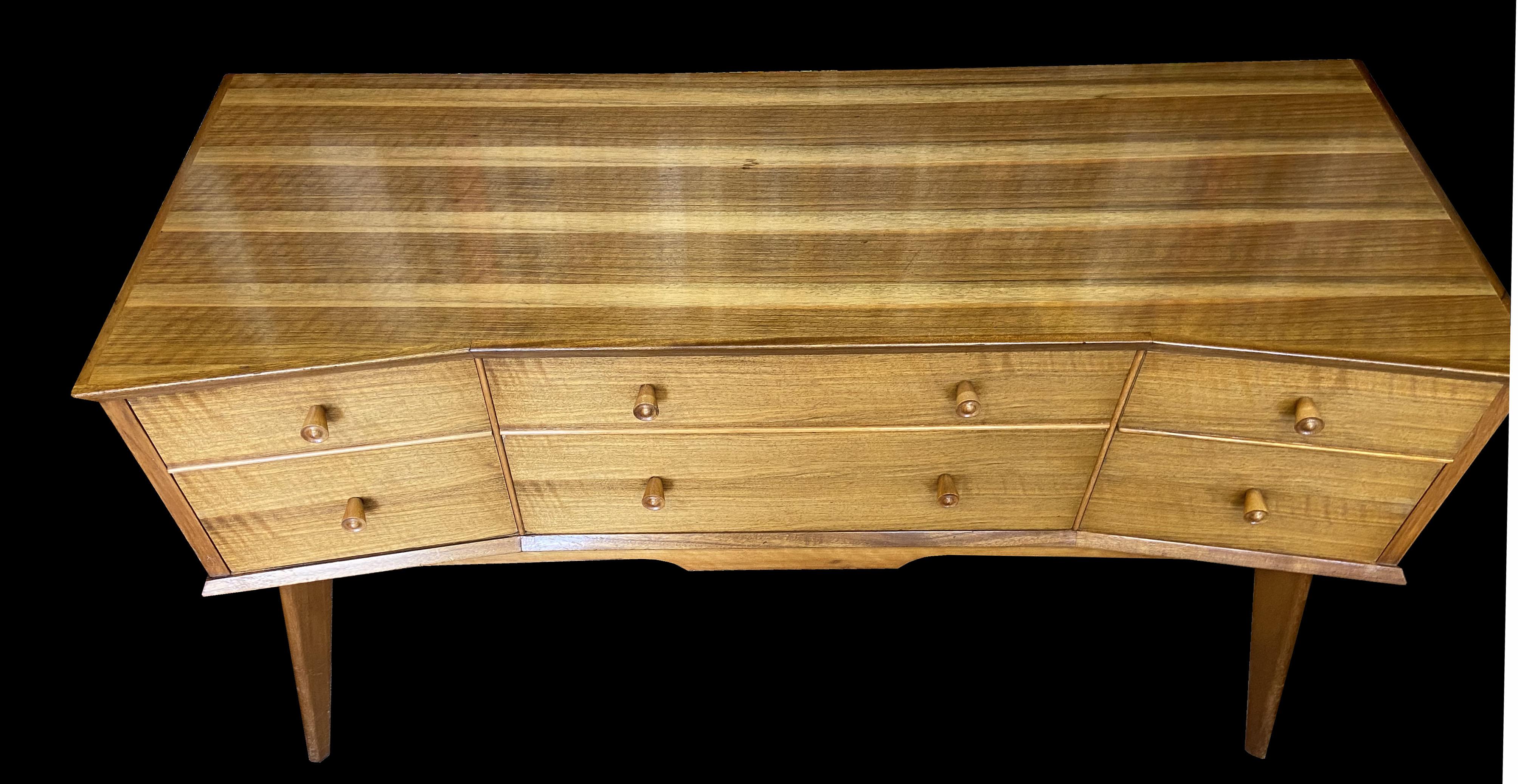 This piece, along with the Chest also listed, are by Alfred Cox who designed for Heal's of London, and made by 'Handcraft'. This lovely Writing or Dressing table is made using maple and Walnut.