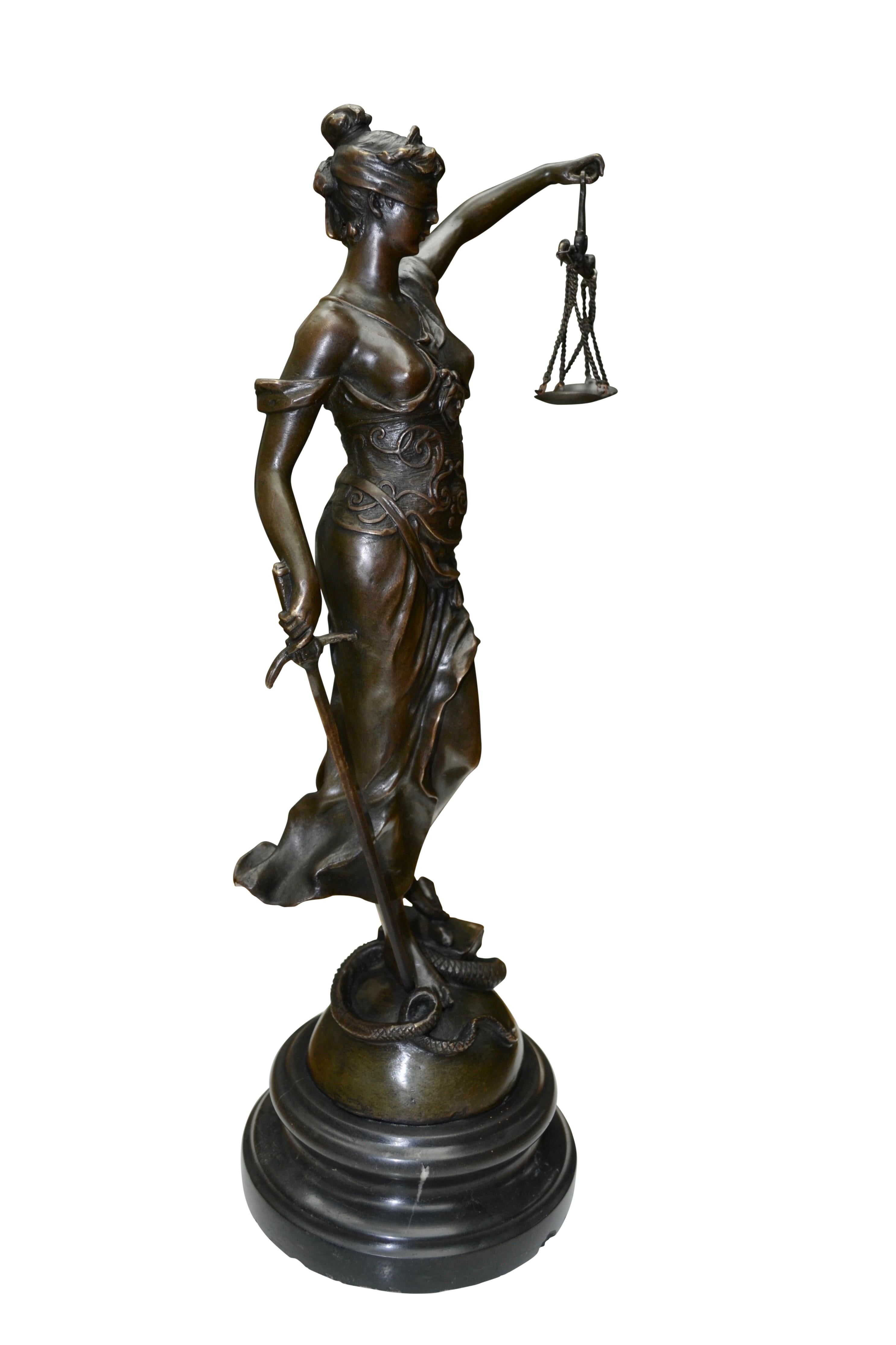 A well cast patinated early 20 century allegorical bronze statue of Lady Justice shown as a bare breasted and classically draped standing maiden blindfolded and holding aloft a two tray balance scale in one hand and a sword in the other while