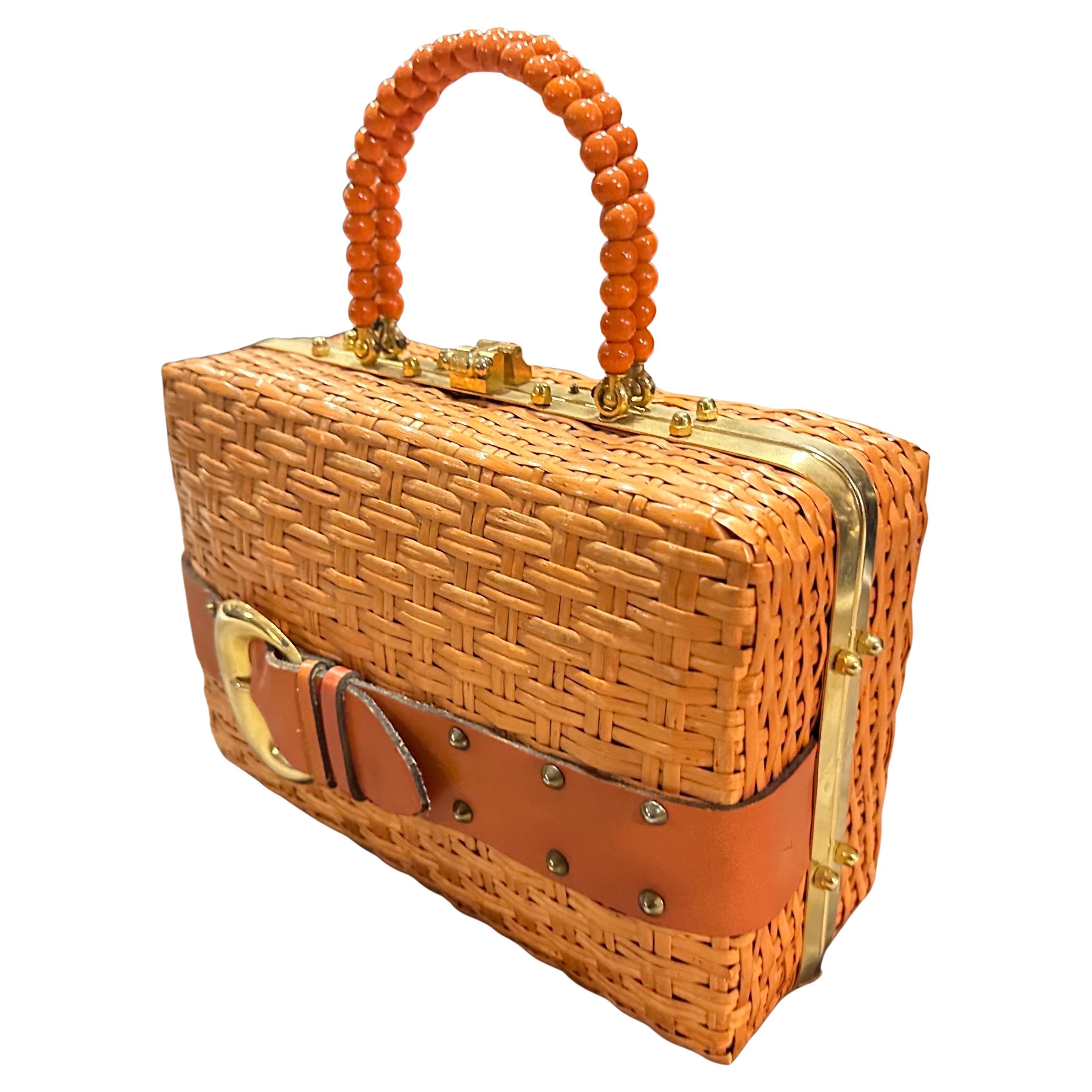 This is a charming and high-quality 1950s Italian handbag that beautifully blends rustic craftsmanship with elegant detailing. Made of natural woven wicker, the bag showcases a tightly interlaced basketweave pattern that gives it a warm, summery,