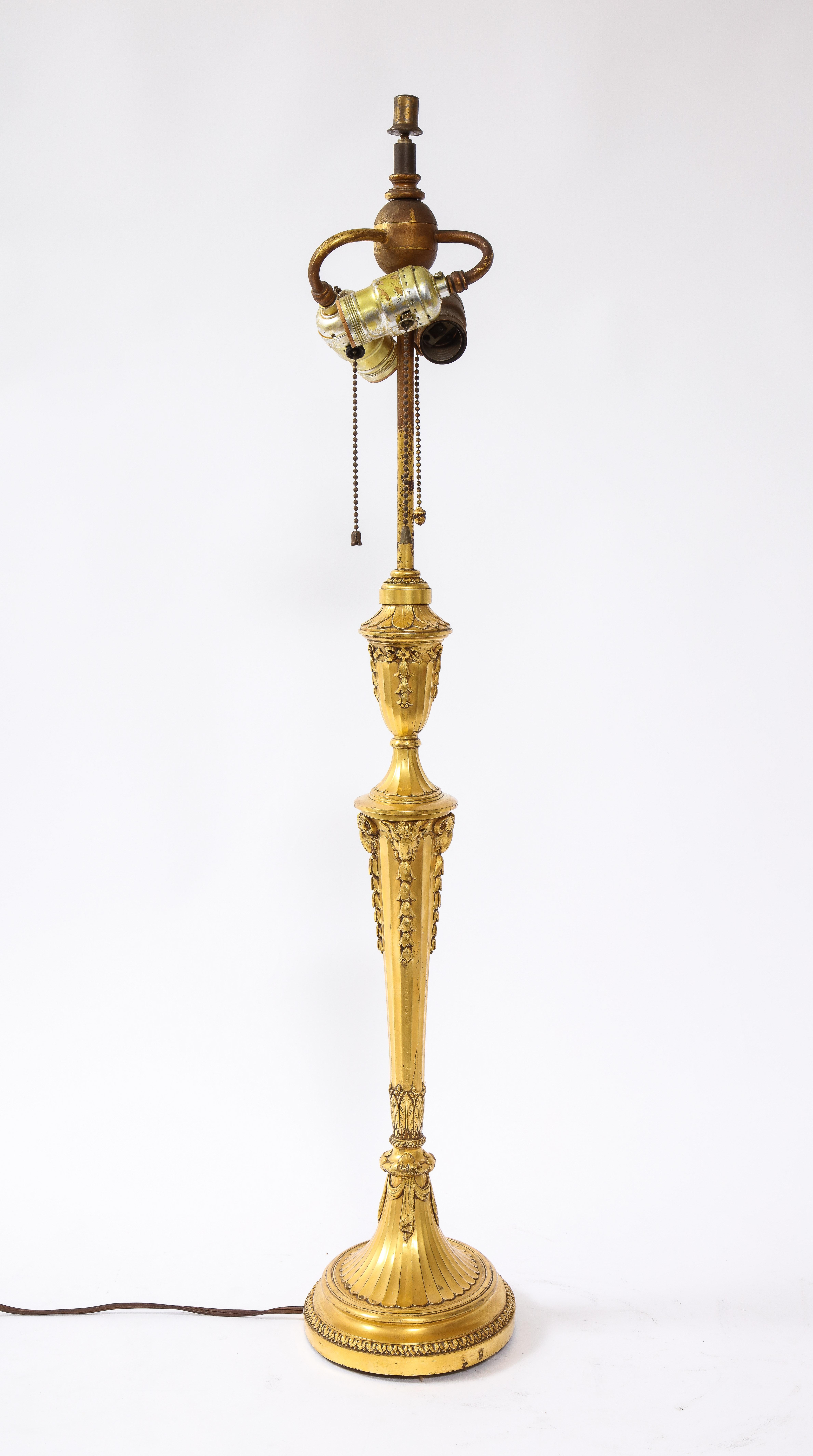 A fantastic 19th century Caldwell Louis XVI style dore bronze candlestick lamp. Beautifully hand-chassed, hand-chiseled with two-tone matte and burnished gold, this lamp is perfect to brighten up any desk or nightstand. It is of gorgeous quality,