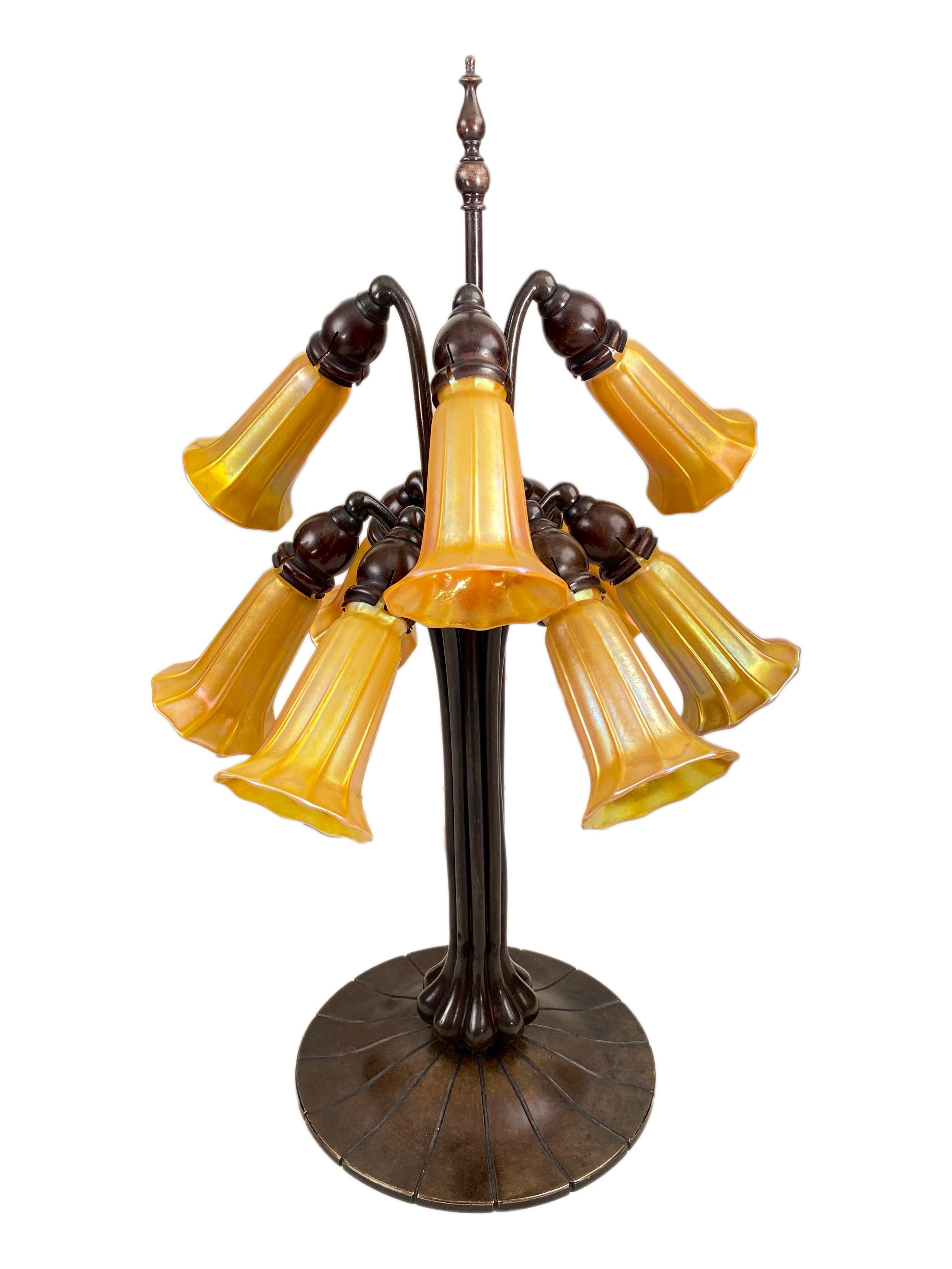 An extremely rare American Art Nouveau cast bronze and blown glass 