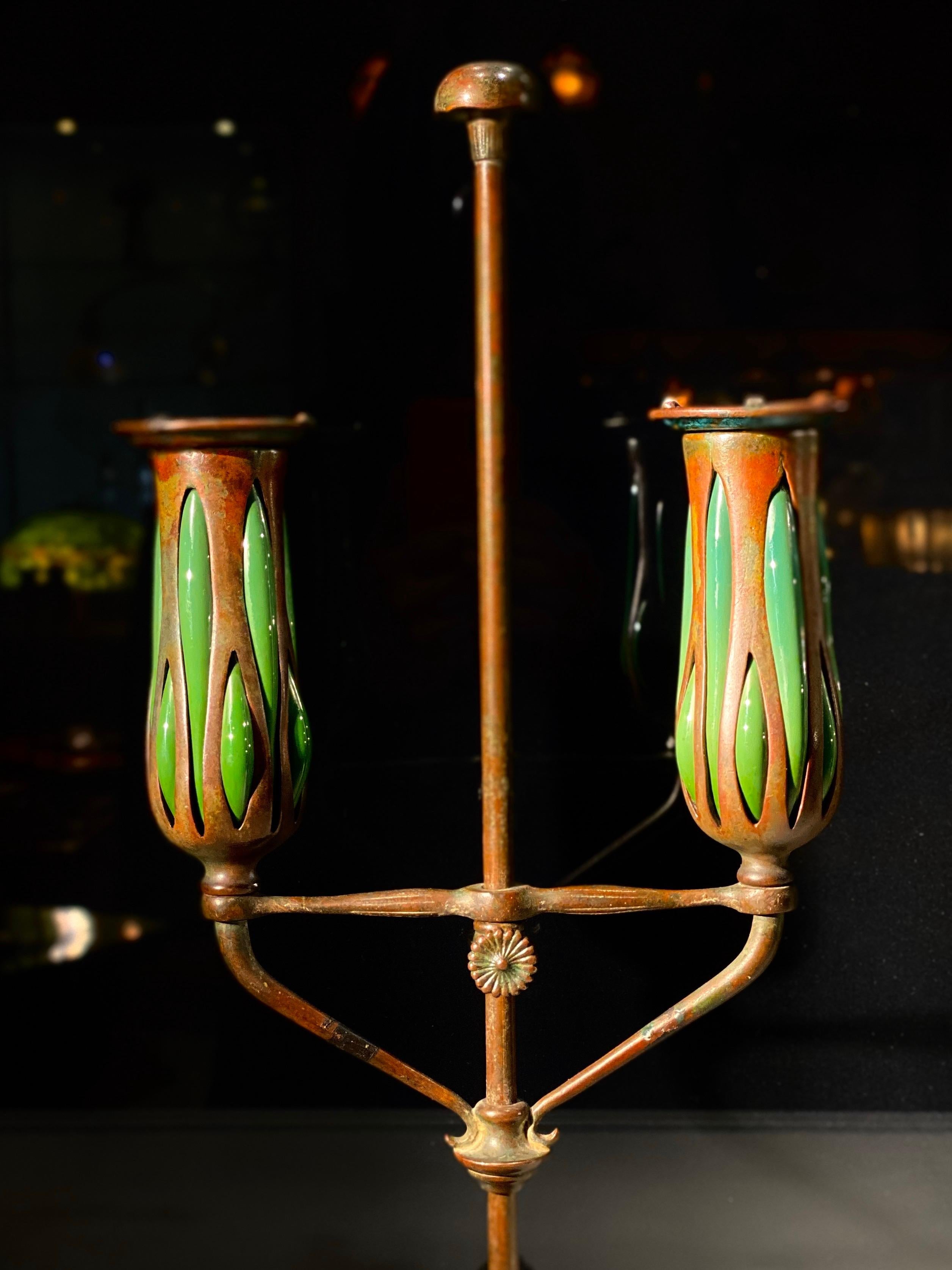 An American Art Nouveau patinated bronze and blown glass 