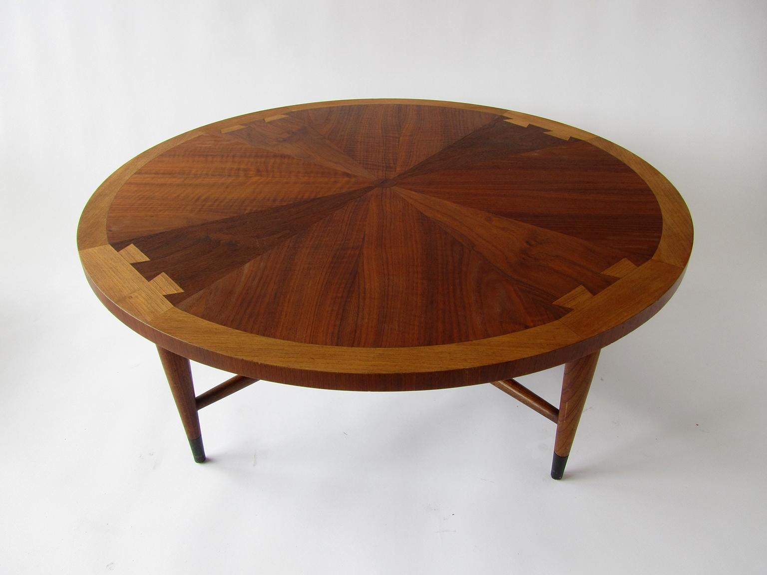 The circular top with alternating woods on tapering legs, marked Lane.