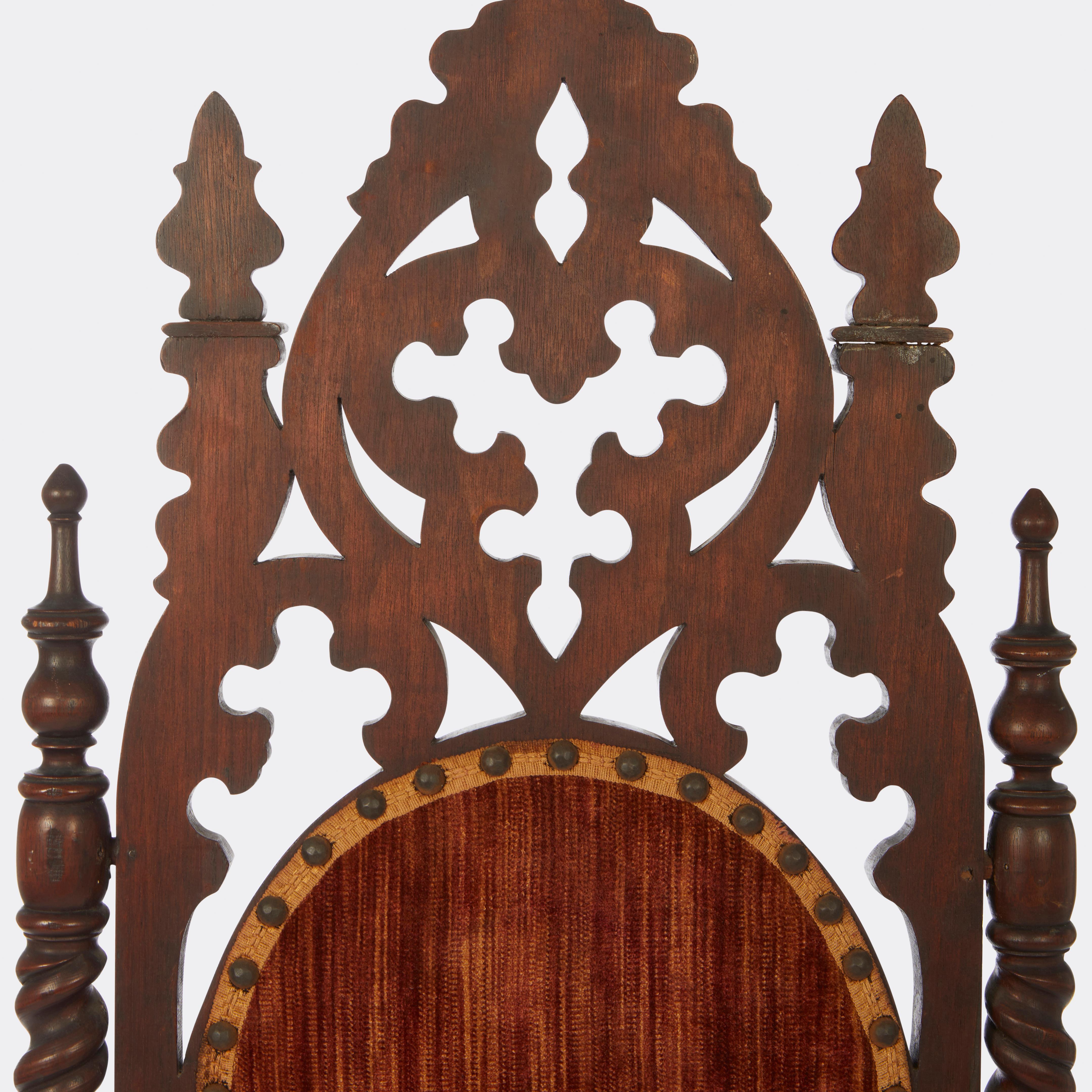 An American Neo-Gothic carved walnut side chair. Tall arched back with carved trefoil motif pierced carving and upholstered panel back and seat. Circa.1870

Seat may need to be reupholstered.
 