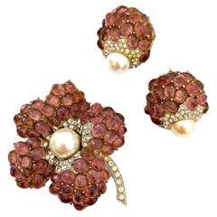 Vintage An amethyst glass cabuchon 'flower' brooch, and earrings, Marcel Boucher, 1960s.