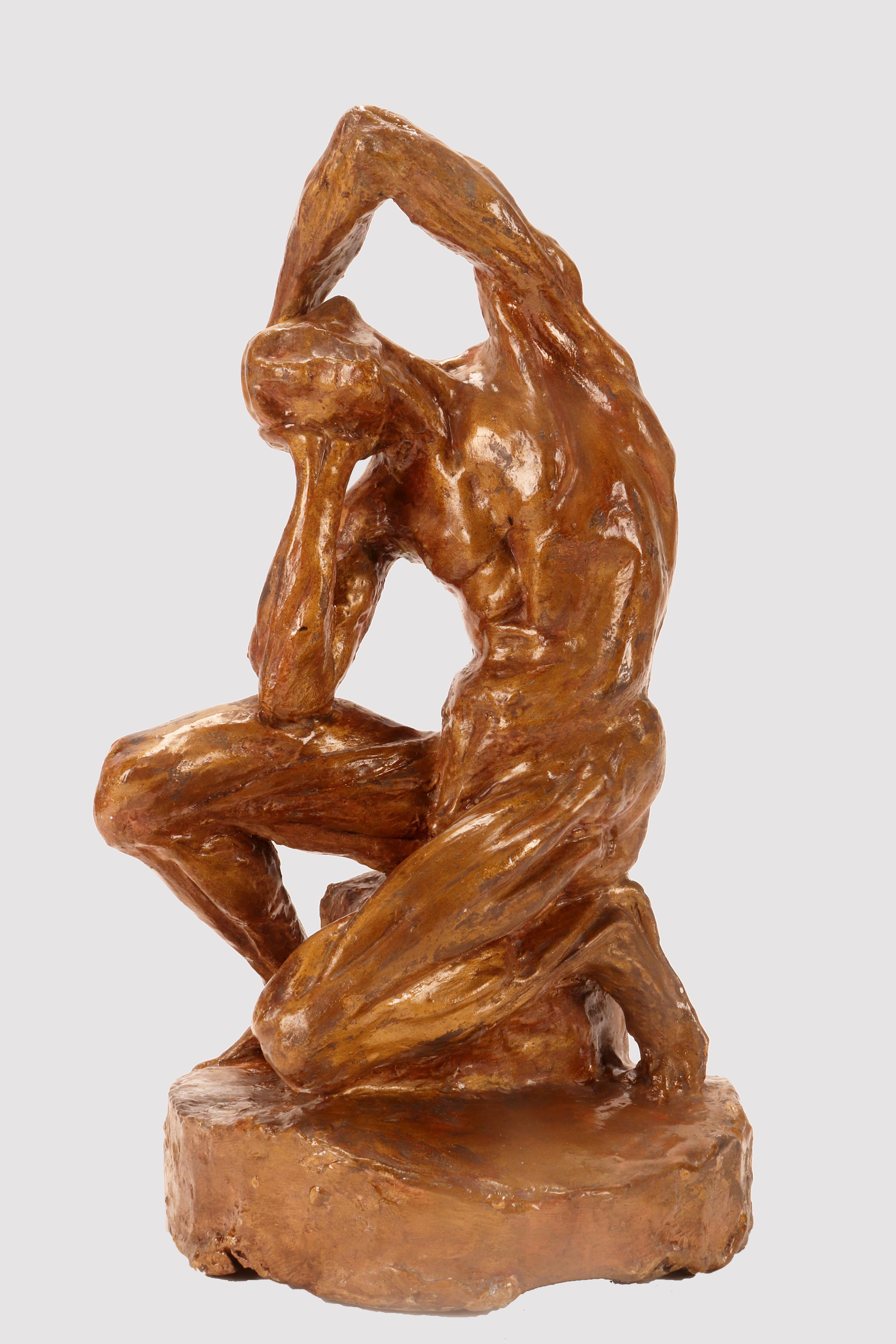 An anatomical plaster sculpture with traces of gilding, depicting a flayed man sitting on a cubic base, in a position with the torso inclined and the arms supporting the head. Reference to a work by the French sculptor Pierre Puget (1620-1694).