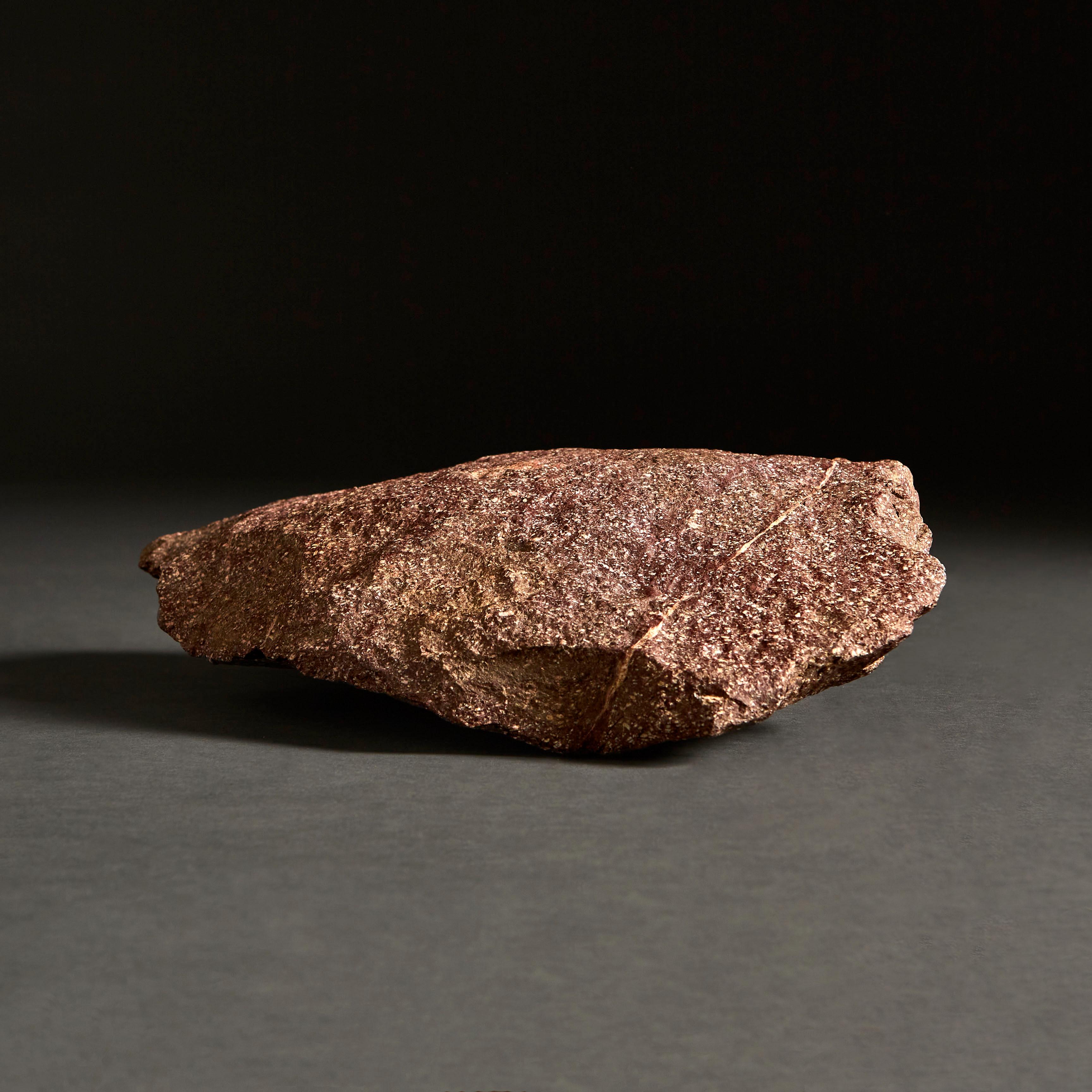A shard of Egyptian Imperial porphyry, with jagged edges.