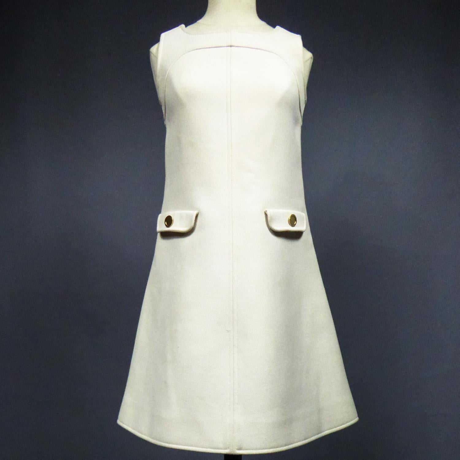 Circa 1968
France

An André Courrèges Haute Couture mini day dress in tchick cream jersey from the end of the 1960s. Honeycomb-shaped cotton jersey with the architectural heaviness of the Gazar frequently used in Haute Couture. Chasuble sleeveless