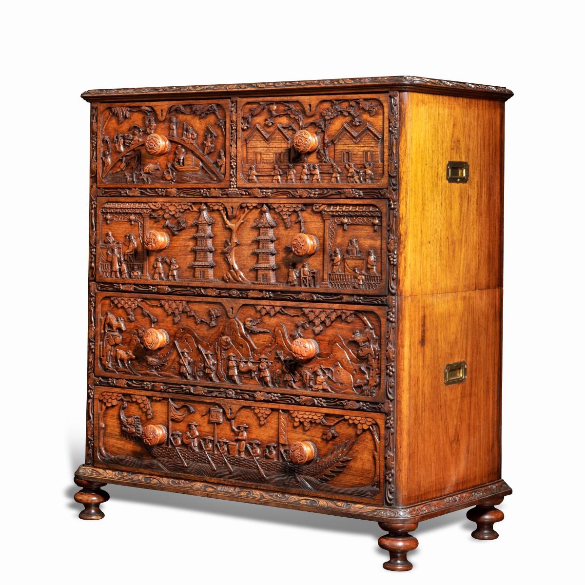 An Anglo-Chinese padouk campaign chest of drawers, 1868. This unusual padouk chest is made in two parts with inset campaign handles for easy transportation.  It has a rectangular top above two short and three long drawers all raised on turned feet. 