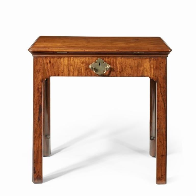An Anglo-Chinese padouk metamorphic architect’s table, this apparently simple table is an infinitely versatile desk.  The rectangular top has a moulded edge.  It opens to create a large reading slope and encloses two candle arms.  The front section