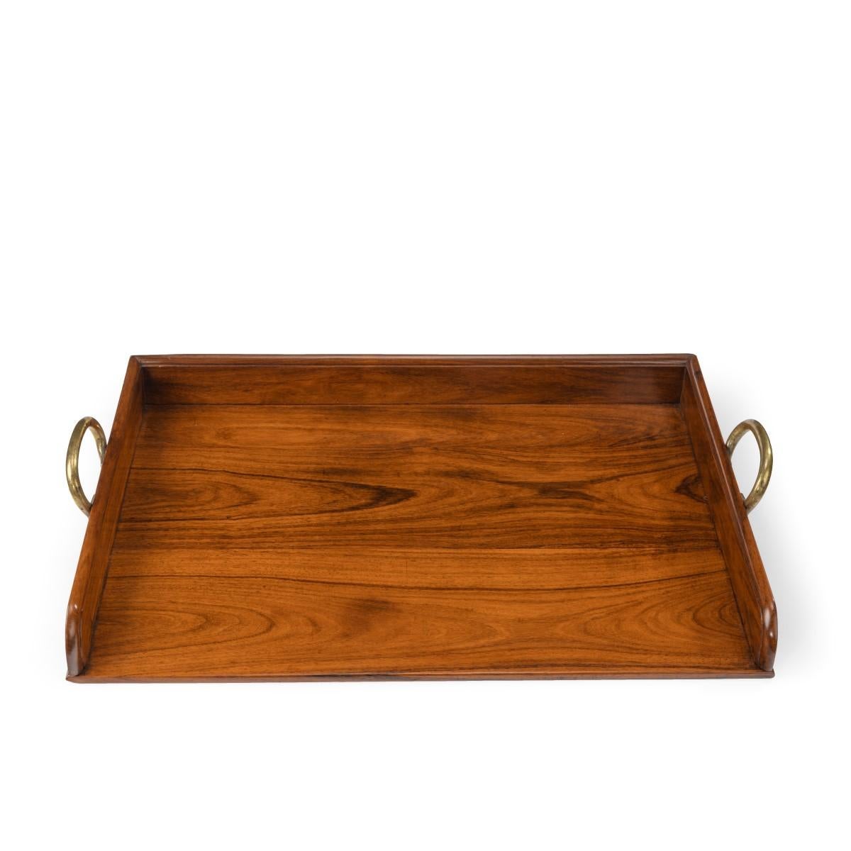 An Anglo-English padouk open butler’s tray, with shaped brass handles, open on one side, circa 1800.