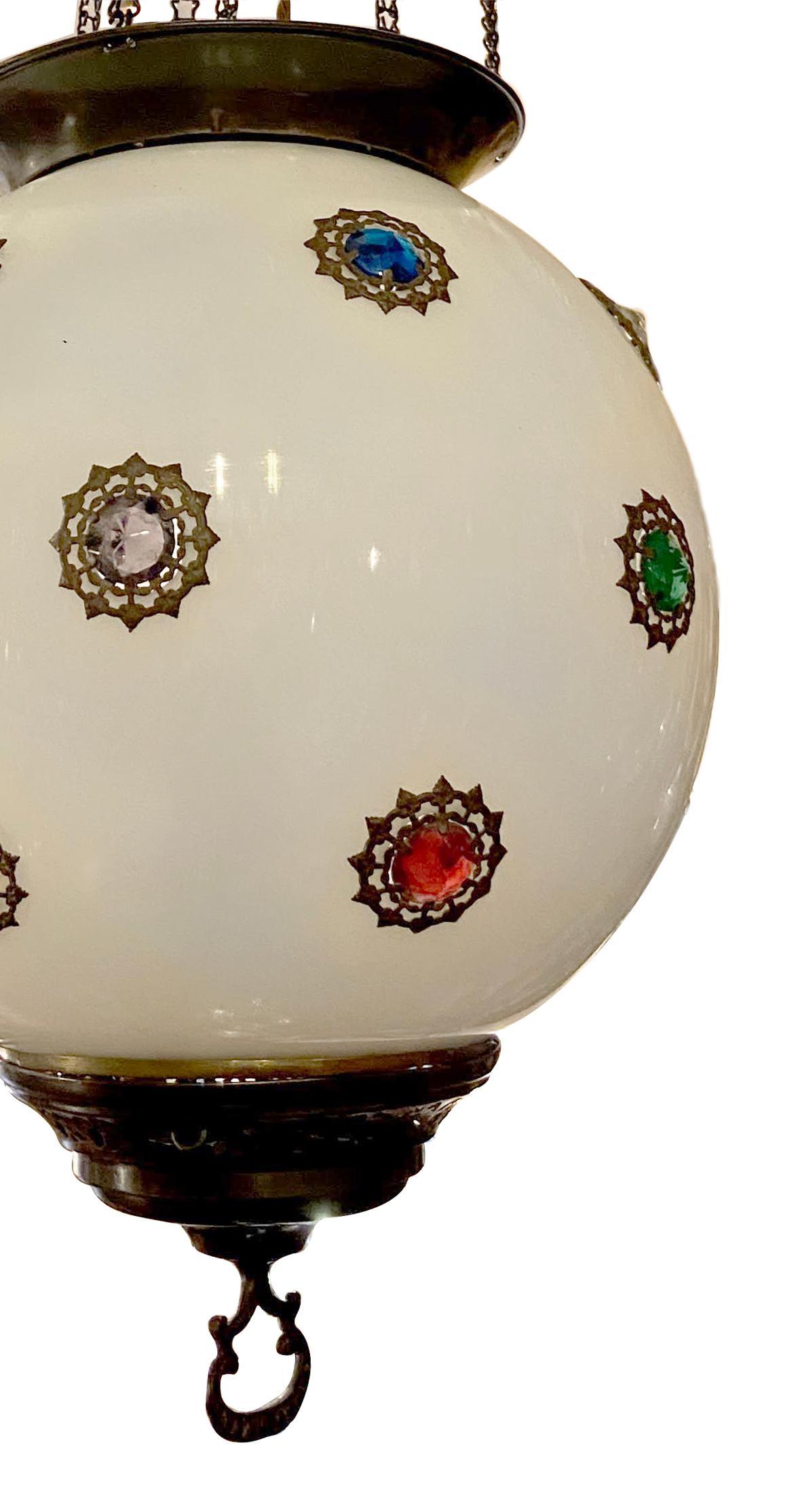 A late 19th century blown opaline glass lantern with colored crystal insets and interior lights.

Measurements:
Diameter 12