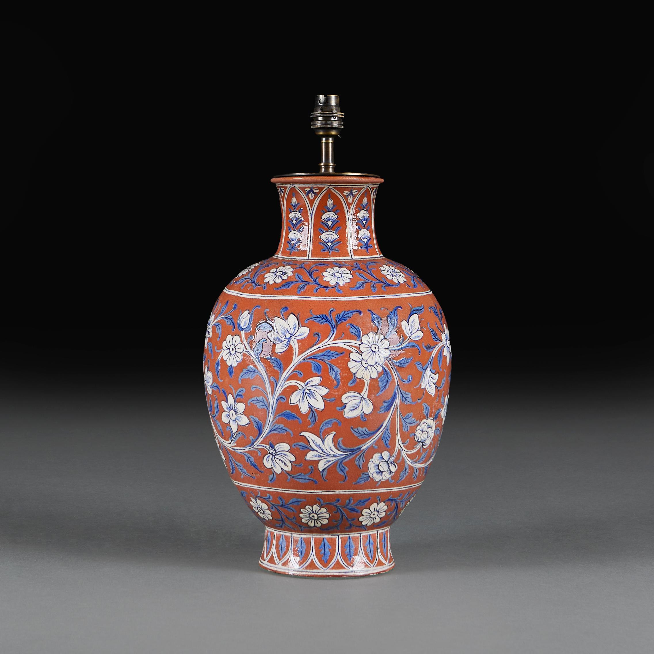 An Anglo-Indian terracotta vase, decorated with blue and white scrolling flowers throughout, now as a lamp.

Please note:

Lampshade not included. Lamp photographed with a 16” diameter pale cream card Pembroke lampshade.

Currently wired for the UK