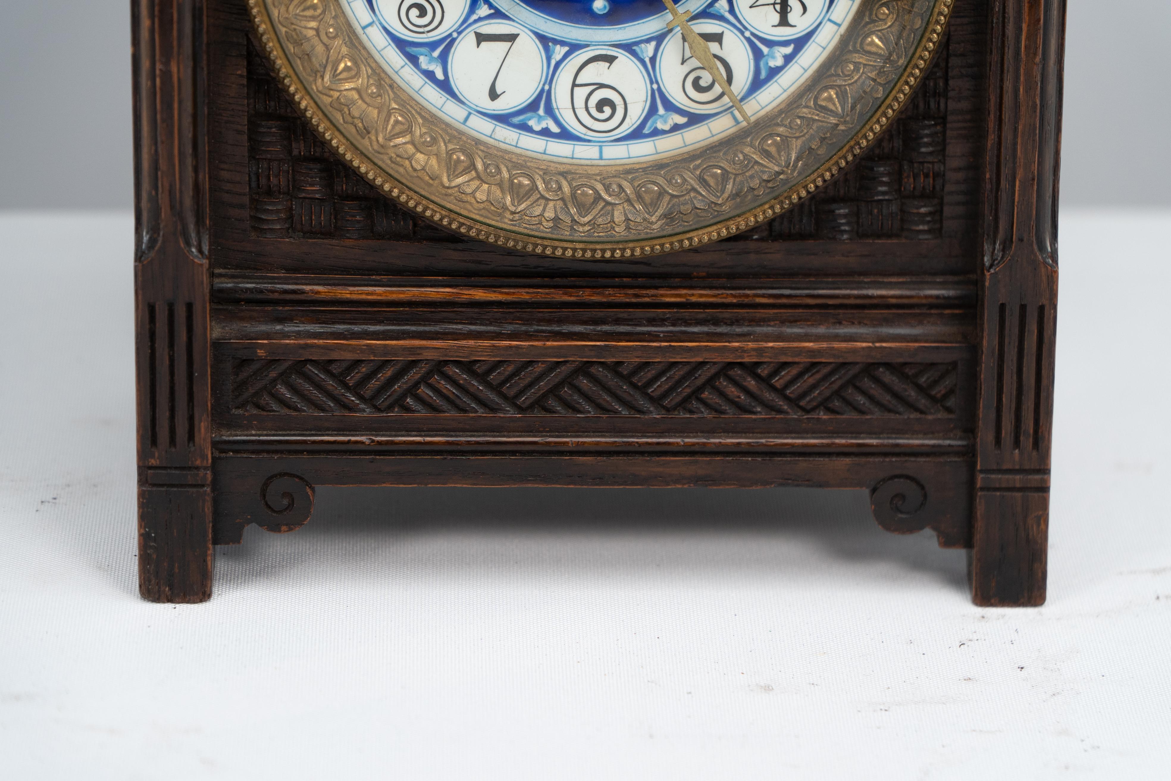 Late 19th Century An Anglo-Japanese carved oak mantel clock with hand painted blue floral dial. For Sale