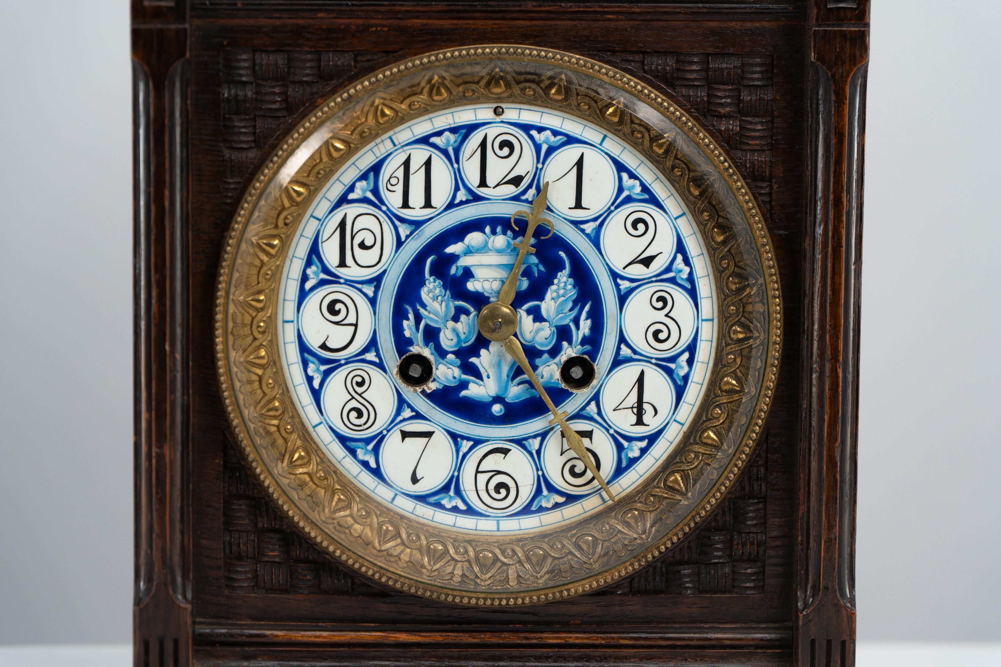 An Anglo-Japanese carved oak mantel clock with hand painted blue floral dial. In Good Condition For Sale In London, GB