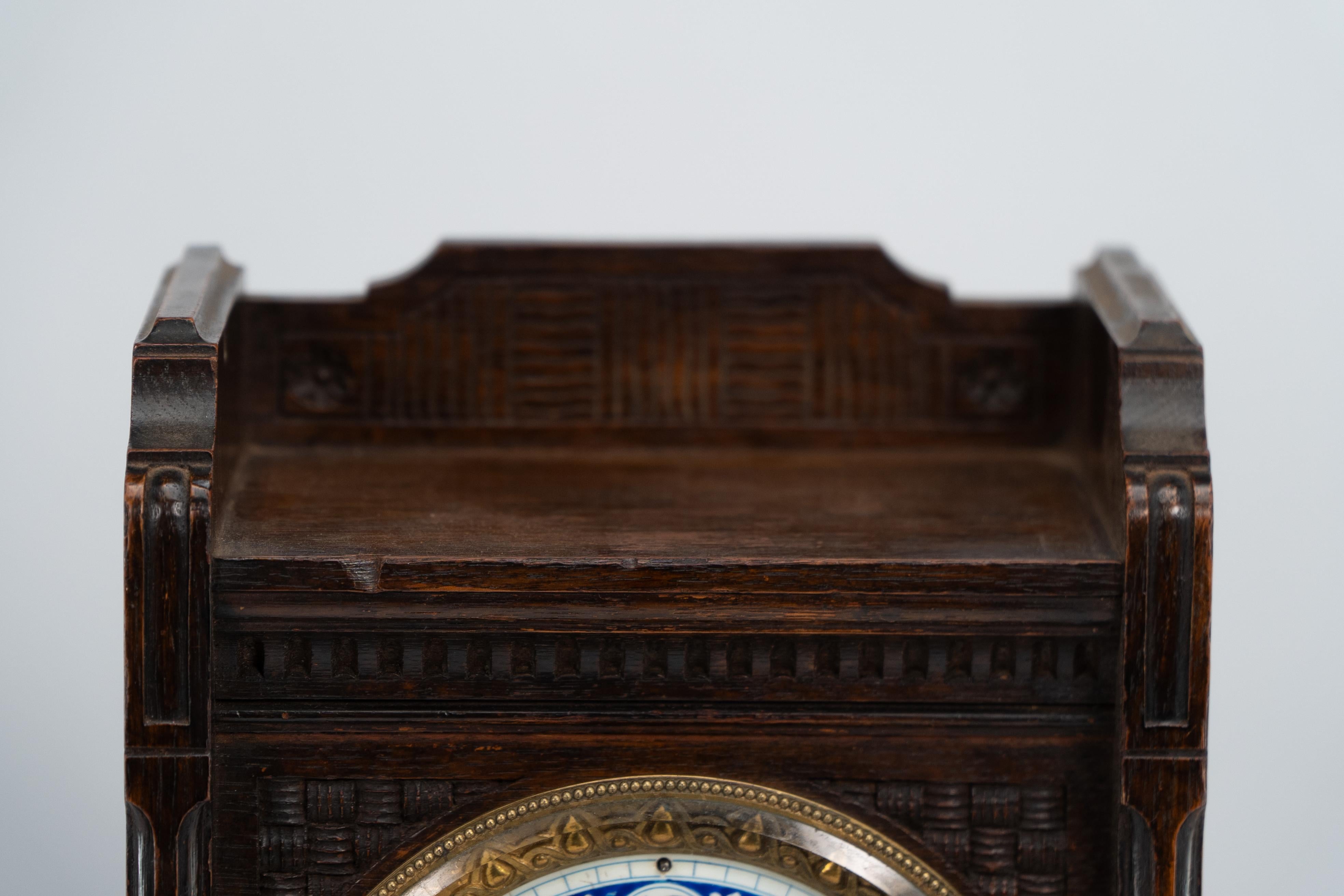 English An Anglo-Japanese carved oak mantel clock with hand painted blue floral dial. For Sale