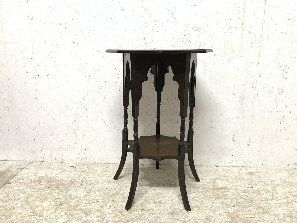 An Anglo-Japanese style walnut side table in the style of E W Godwin.
With decorative shaped arches below the octagonal top, connecting five turned and square shaped legs, united by a star shaped ten point lower shelf, standing on out swept feet.