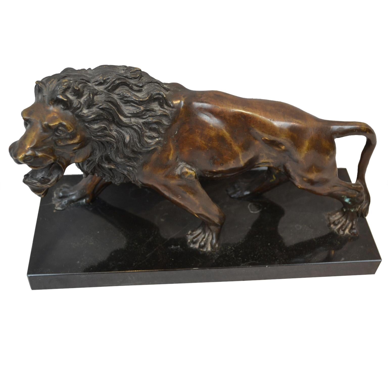 A late 19th century cast bronze of a growling lion in dark brown patinated bronze; unsigned and mounted on a rectangular black marble base.